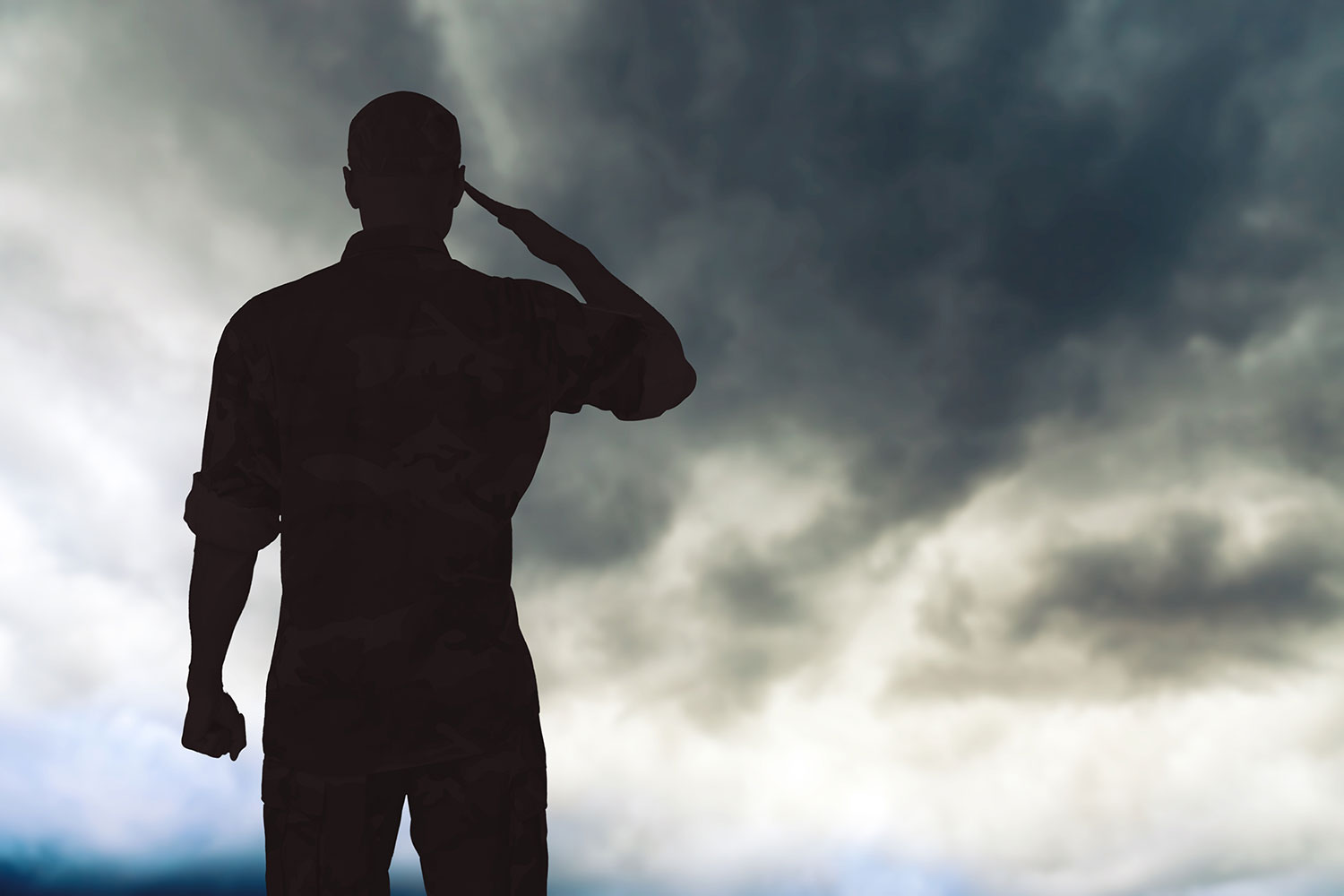 A veteran salutes a stormy sky
